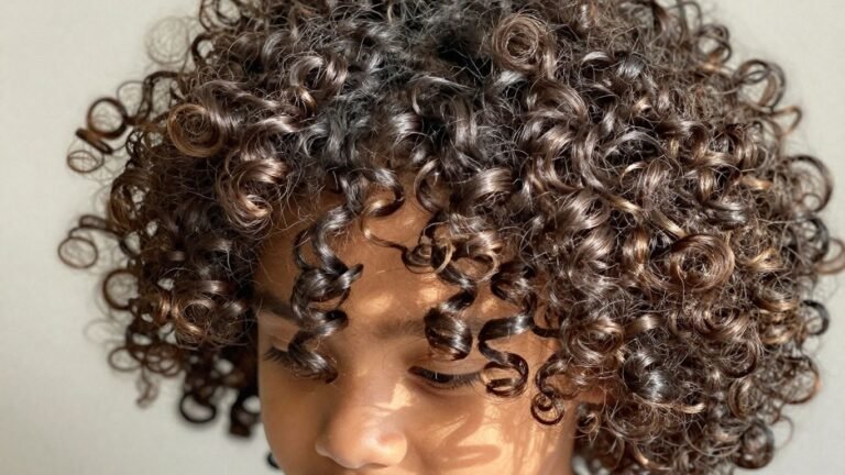 Child with healthy, shiny mixed-race curly hair.